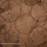 Grunge background texture of flat brown kraft paper completely covered in overlapping, dark coffee cup ring stains