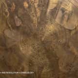 High-quality close-up detail of a circular brushed brass or bronze metal texture in 4K. Distinct circular scratches, microscopic dents, and wear are visible on the golden raw surface.