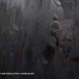 Extreme close-up of a dark, almost black raw steel texture. The metallic surface is heavily scratched and features a colorful, iridescent oily stain on the right side, showing insane quality and resolution.