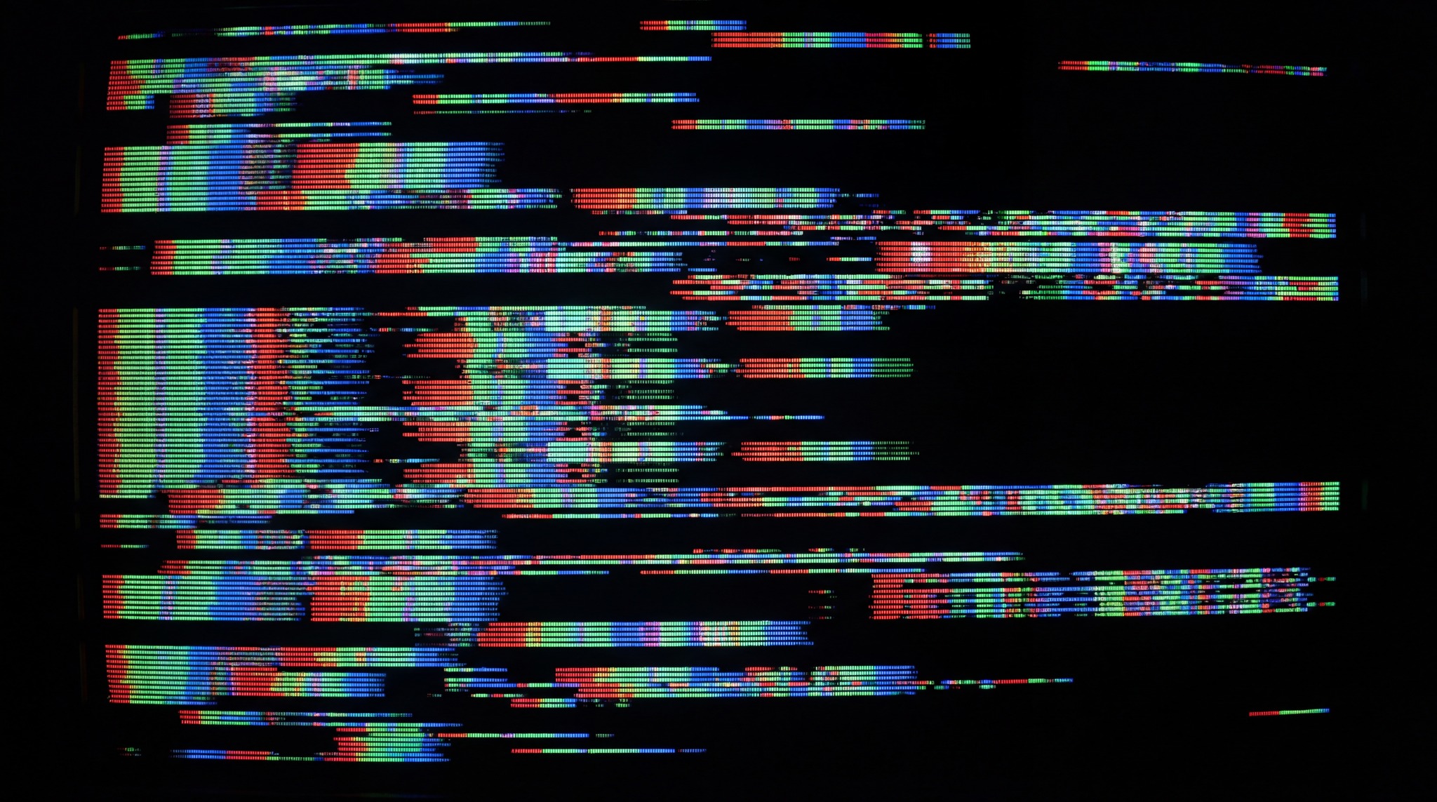 A digital screen displaying corrupted scanlines with vibrant red, green, and blue color bleeding effects against a black background.