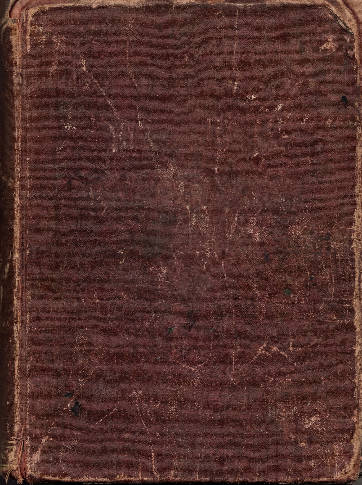 A close-up, top-down view of a worn, dark brown leather book cover with visible scuffs and scratches.