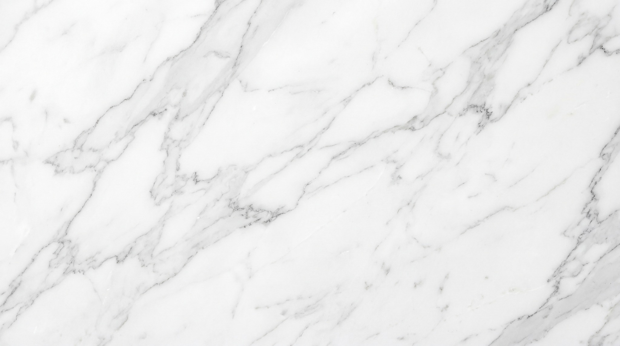 A high-resolution texture of white marble with delicate, intricate grey veining.