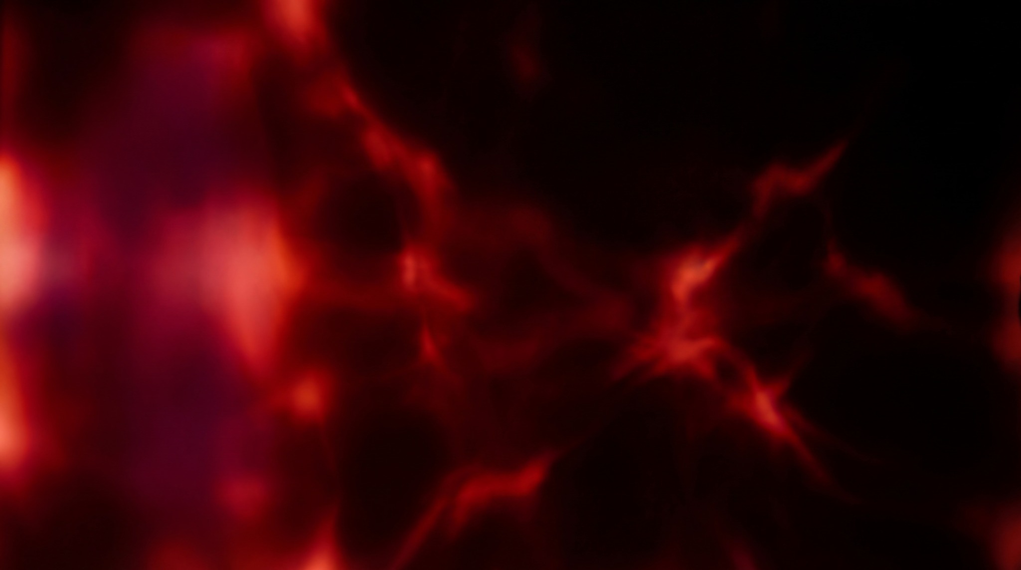 Abstract red organic light leak texture with glowing veins and dark background.