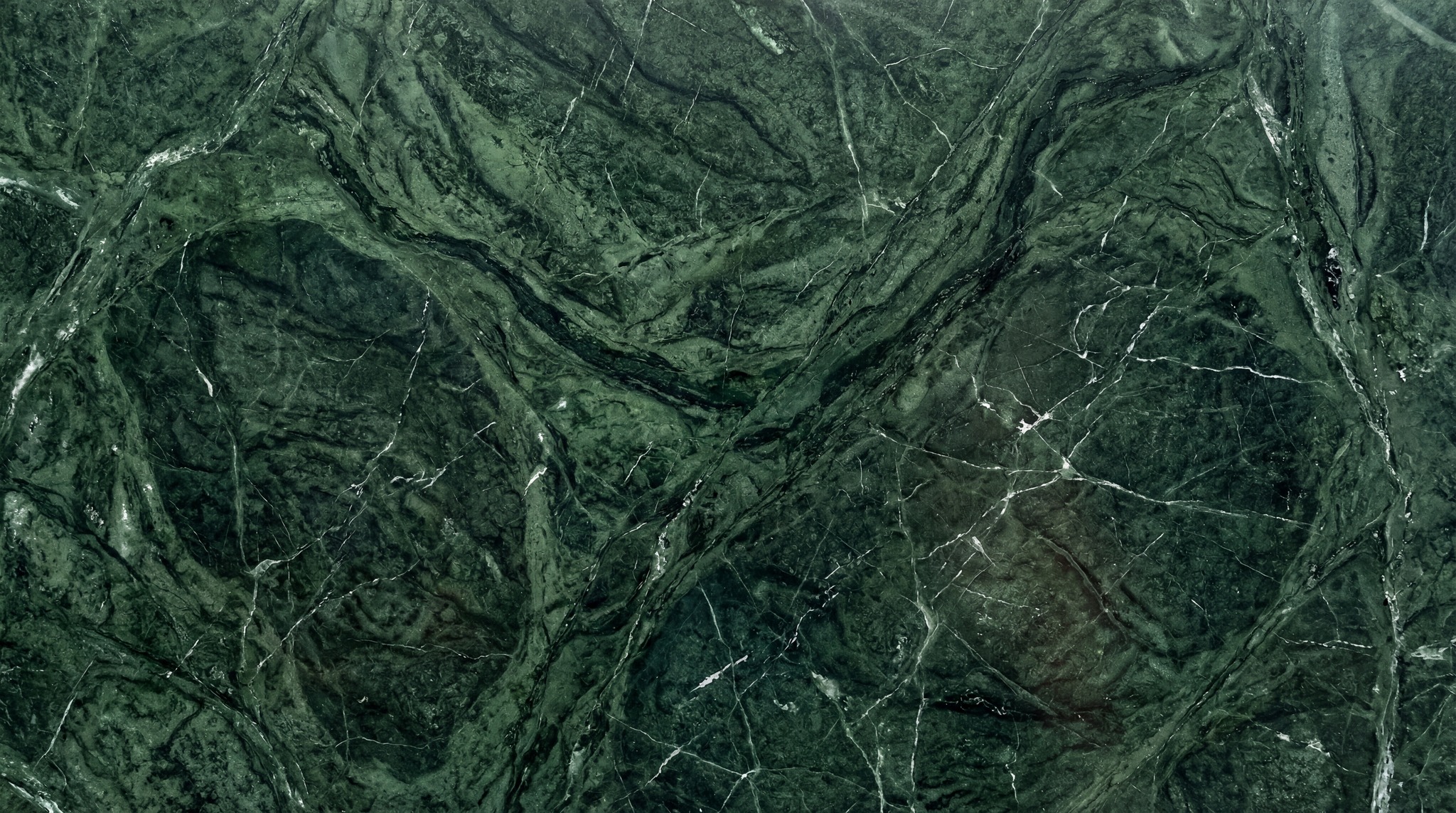 A high-resolution texture of emerald green marble with intricate white swirling veins.