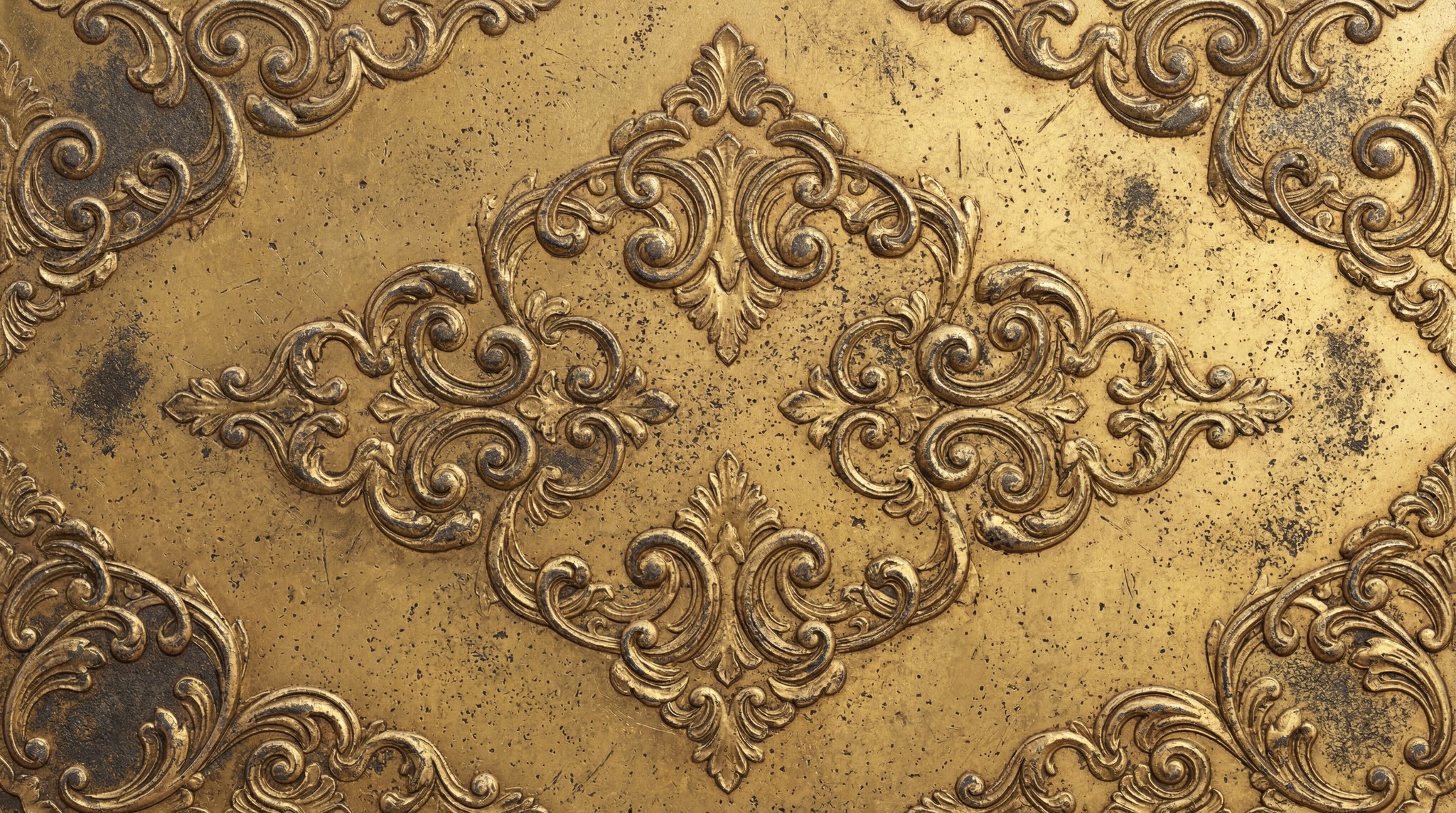 Close-up of a golden metal surface with intricate baroque-style relief carvings.