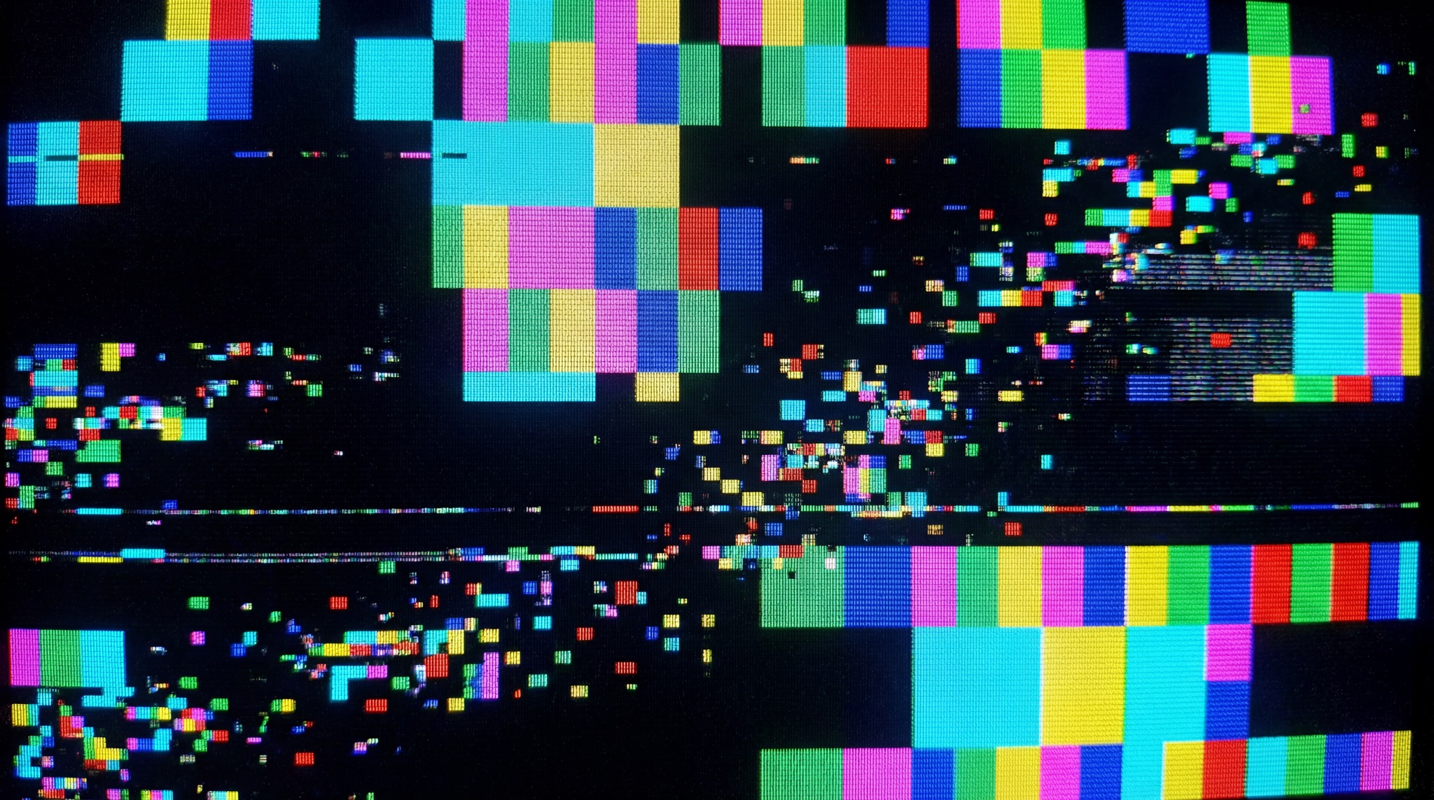 A digital texture displaying a chaotic GPU kernel panic with vibrant, corrupted colors and scattered pixel fragments.