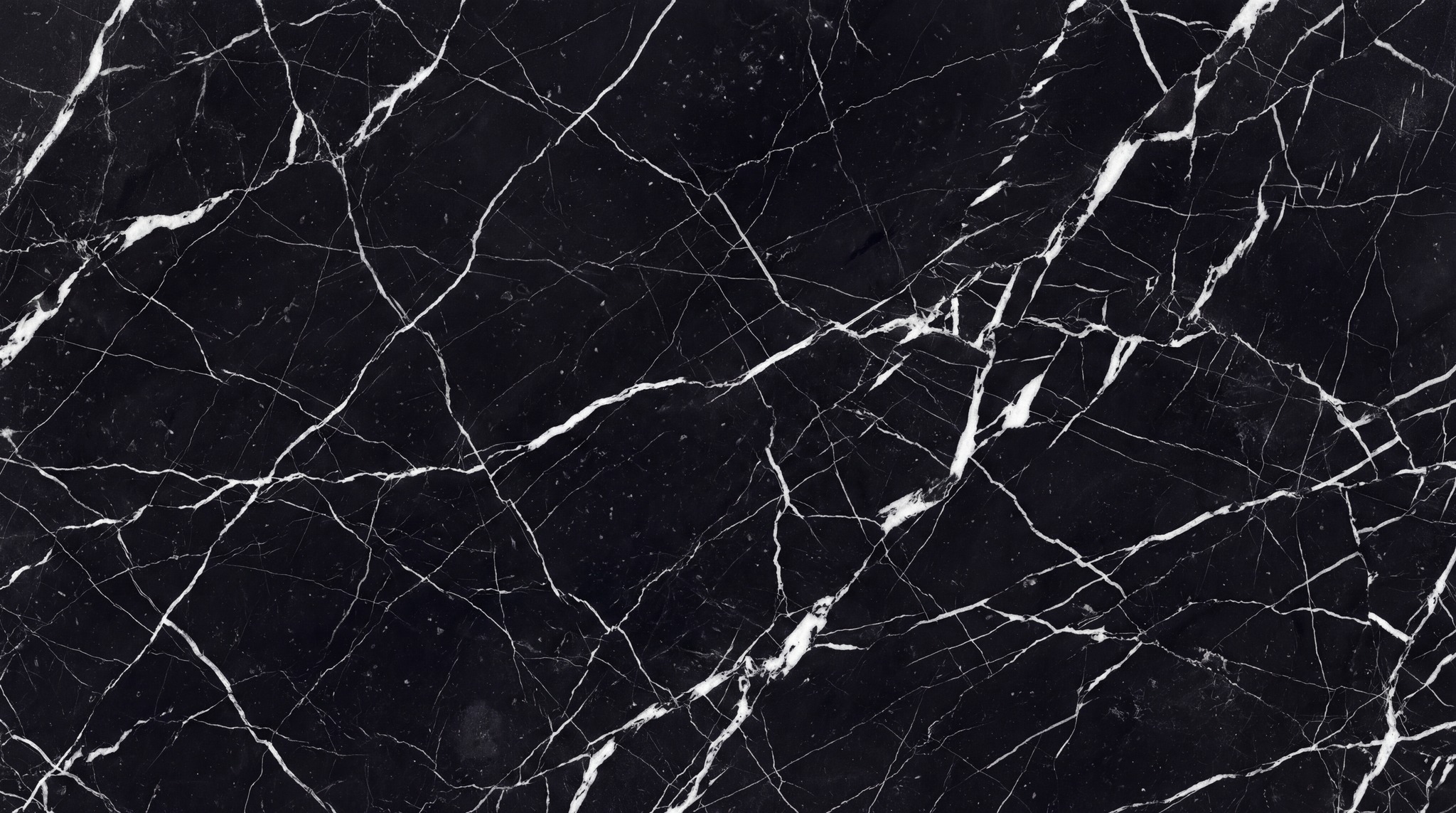 A seamless texture of polished black marble with intricate white veining.