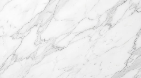 A high-resolution texture of white marble with delicate, intricate grey veining.