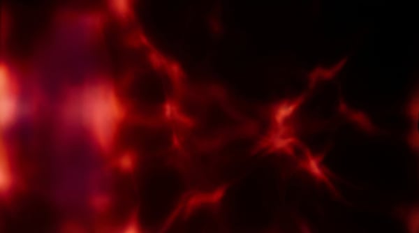 Abstract red organic light leak texture with glowing veins and dark background.