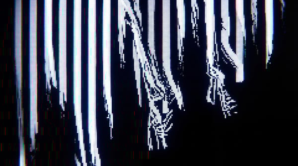 Abstract black and white digital glitch texture with vertical white and gray lines that are distorted and fractured, resembling analog video signal degradation.