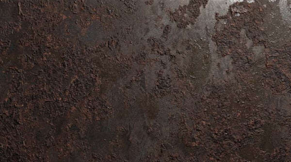 Close-up view of a heavily rusted metal surface with dark brown and reddish-brown textures and fine horizontal lines.