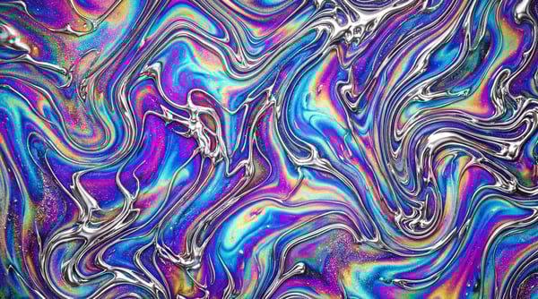 A close-up view of an iridescent marble texture with swirling patterns of blue, purple, pink, and silver liquid chrome.