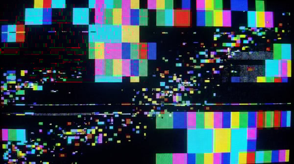 A digital texture displaying a chaotic GPU kernel panic with vibrant, corrupted colors and scattered pixel fragments.