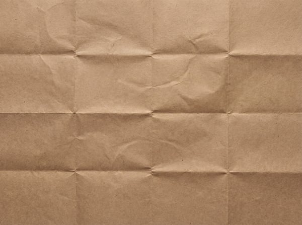 A seamless, unfolded brown kraft paper texture with grid-like fold creases.
