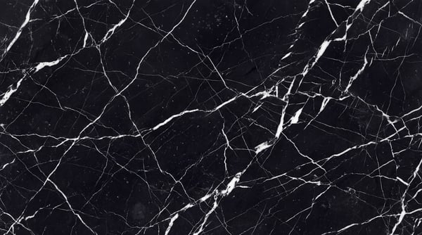 A seamless texture of polished black marble with intricate white veining.